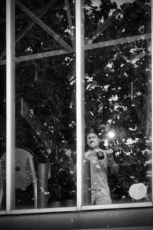 Man strenuously working out in the gym. A moment immortalised by photographer Peter Pickering